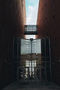 Buildings against sky seen through glass window