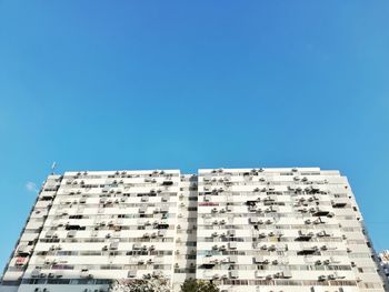 Low angle view of building against clear blue sky