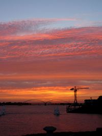 Scenic view of sea against orange sky