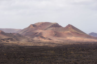 Scenic view of arid landscape against sky