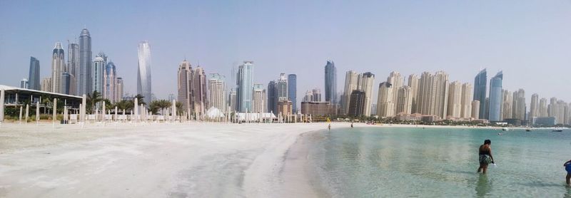 Panoramic view of city buildings against clear sky