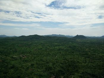 Scenic view of green landscape against sky