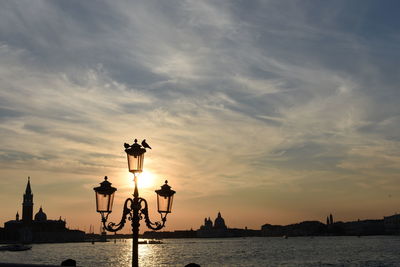 Street light in city at sunset