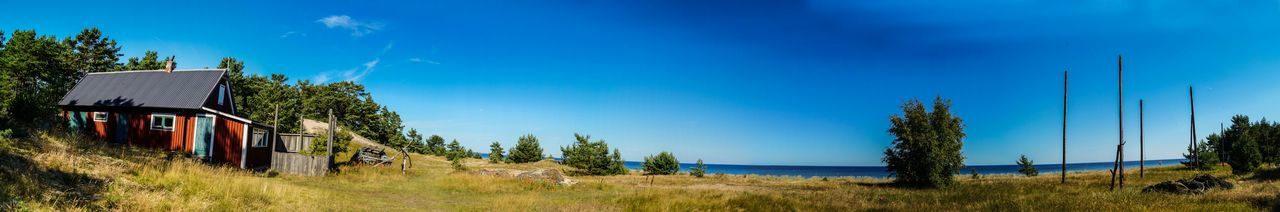 Houses on landscape against blue sky