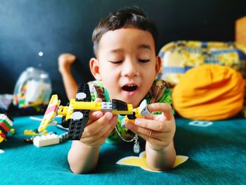 Portrait of boy playing with toy toys