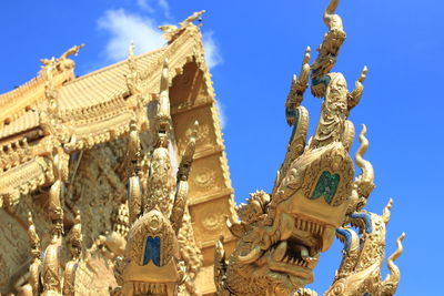 Low angle view of statue against blue sky