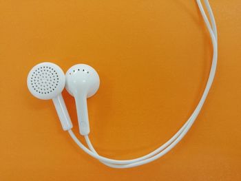 High angle view of telephone booth against orange wall