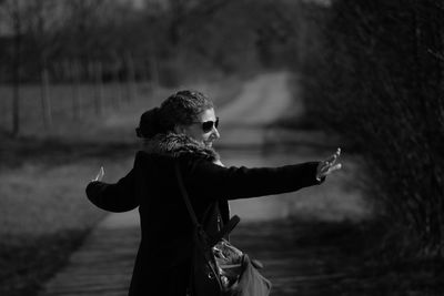 Smiling mature woman dancing in park