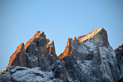 Low angle view of rock formation against clear blue sky