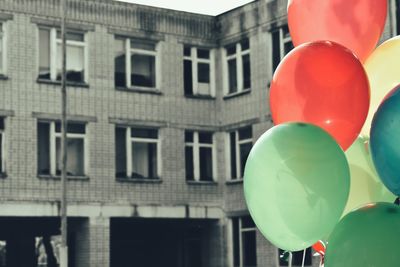 Low angle view of balloons against building