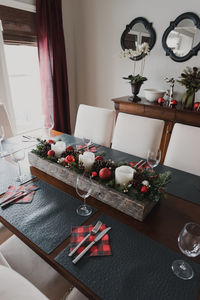 Table set for a formal christmas holiday dinner in a dining room.