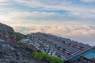 Low angle view of building against cloudy sky