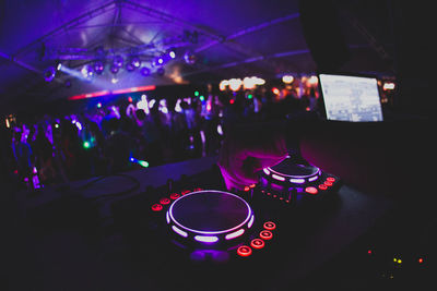 Cropped hand of dj playing music in nightclub