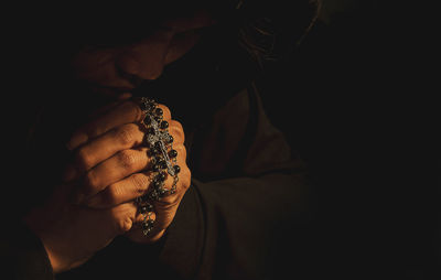 Close-up of woman hand over black background