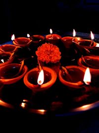 Close-up of lit candles in temple