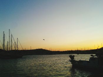 Sailboat in sea at sunset