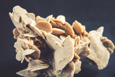 Close-up of cookies on table against black background