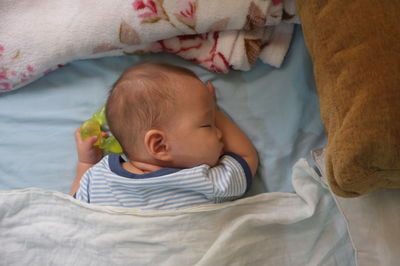 High angle view of baby sleeping in bed