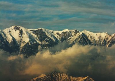 Scenic view of snowcapped mountains against sky