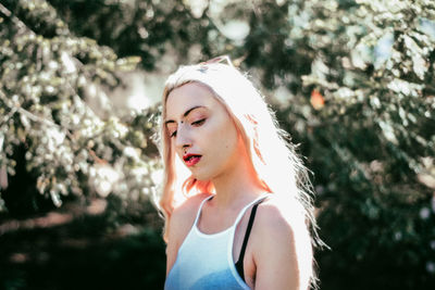 Woman against plants during sunny day