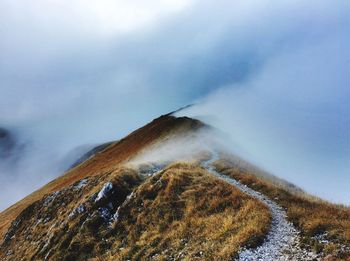 Aerial view of snow covered mountain against sky