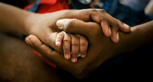 Cropped image of couple holding hands