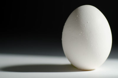 Close-up of ball on table against black background