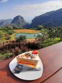 High angle view of food served on table against mountains