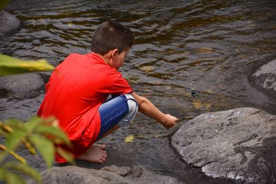 High angle view of boy on rock