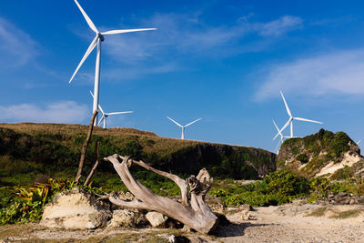 Windmill on field against sky