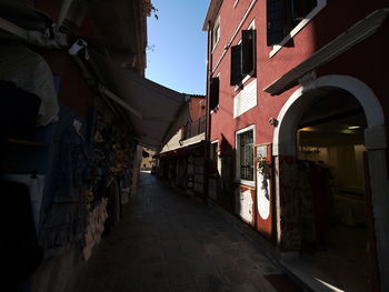 Narrow street amidst buildings in city