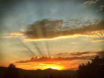 Scenic view of silhouette mountains against sky during sunset