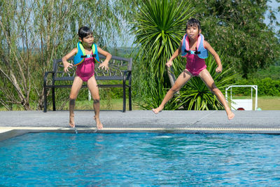 Full length of woman exercising in pool