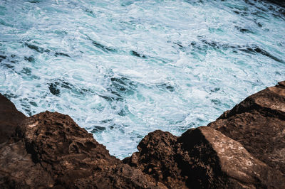 High angle view of rocks in sea