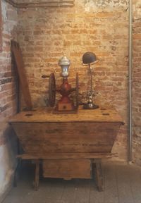 Old electric lamp on table against wall