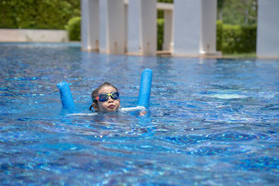 Portrait of man swimming in pool