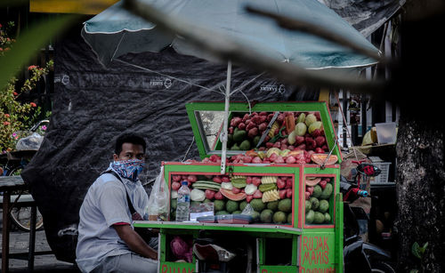 Portrait of young man for sale at market stall