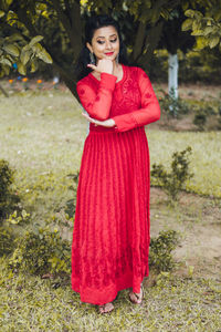 Portrait of young woman standing outdoors