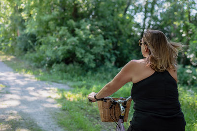 Midsection of woman standing by plants in basket