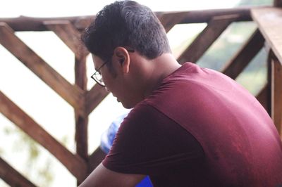 Man sitting by railing