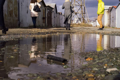 Reflection of man in puddle