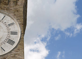 Low angle view of clock tower against sky