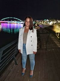 Portrait of smiling woman standing at night