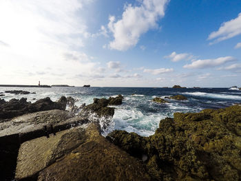 Scenic view of sea against cloudy sky