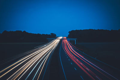 High angle view of light trails on highway at night