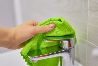 Close-up of hand holding green leaf