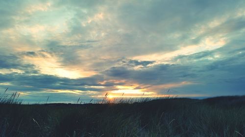 Scenic view of landscape against cloudy sky