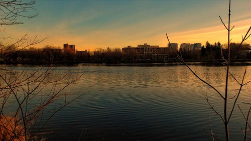 Scenic view of lake against sky at sunset