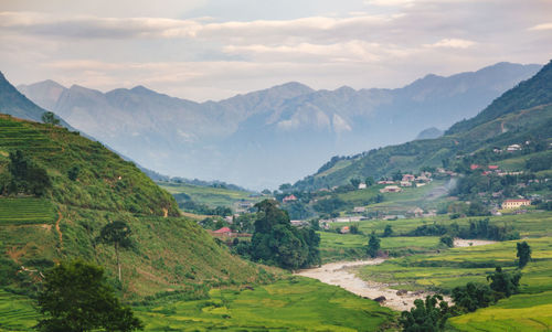 Scenic view of agricultural field and mountains against sky