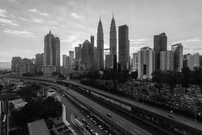 Panoramic view of road amidst buildings in city against sky